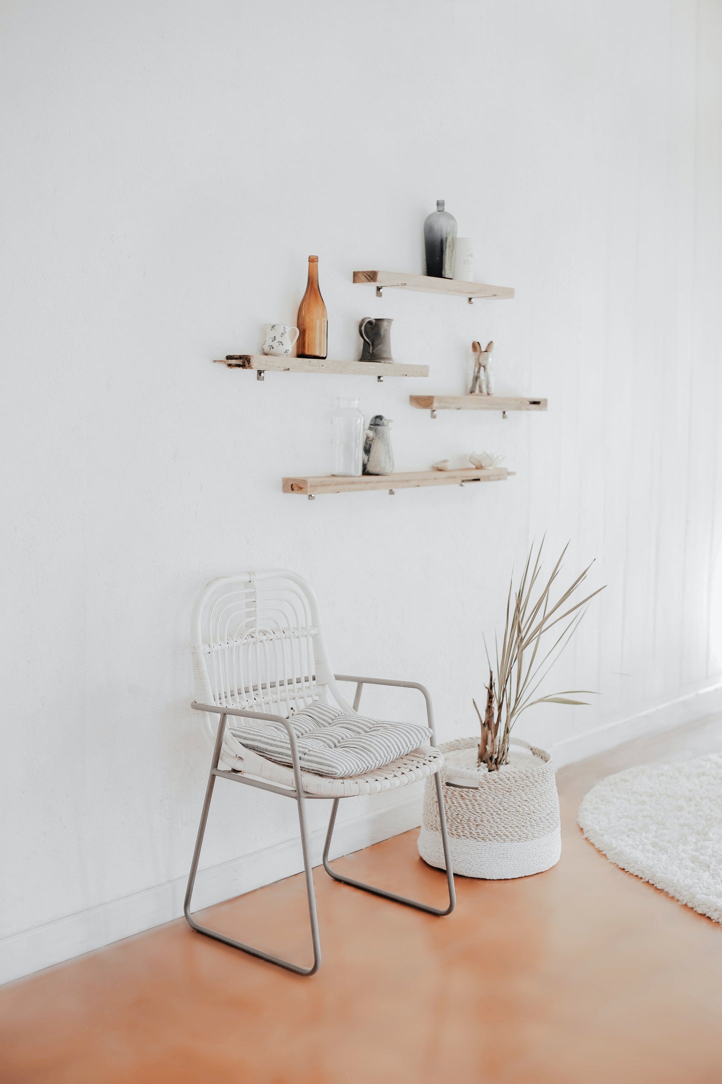 One wall of an apartment is sparsely decorated with a modern minimalist aesthetic.
