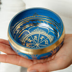 Tranquil Aura singing bowl held in the hand, striker ready
