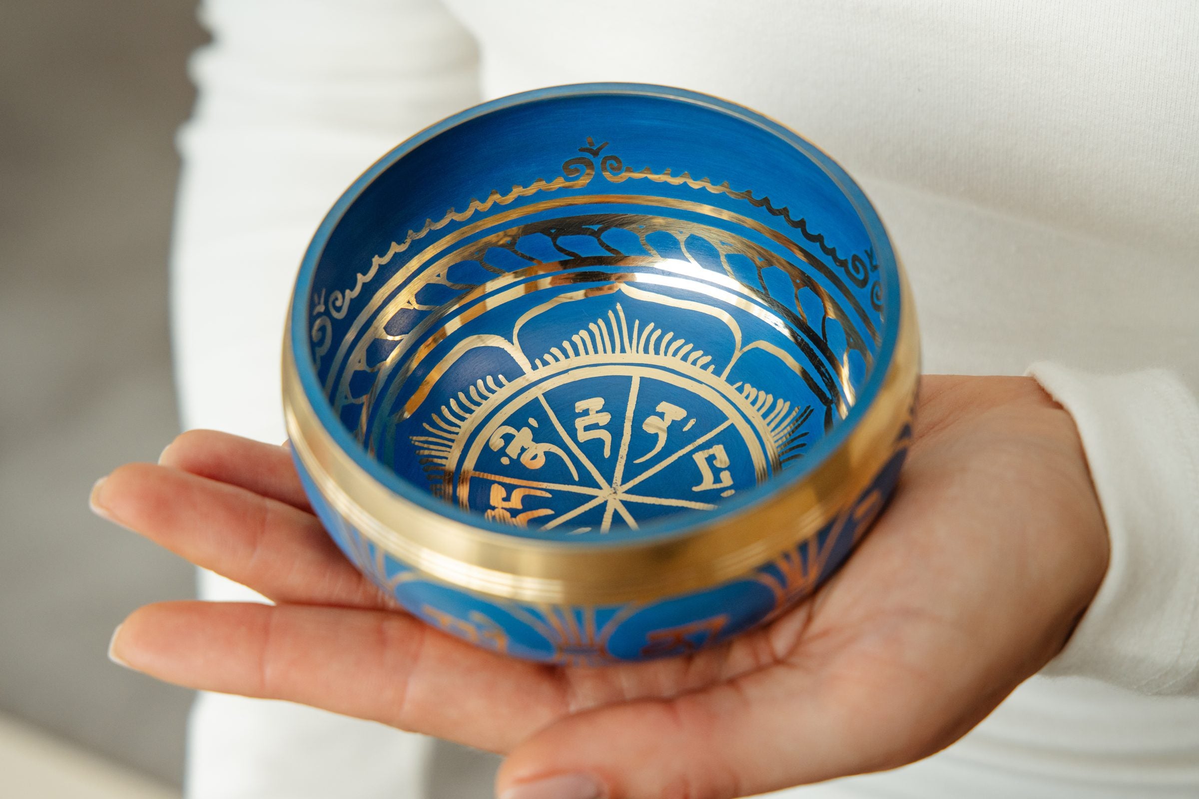 Tranquil Aura singing bowl held in the hand, striker ready