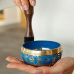 Tranquil Aura singing bowl held in the hand, striker ready