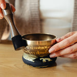 Golden Serenity singing bowl being played with the wooden striker