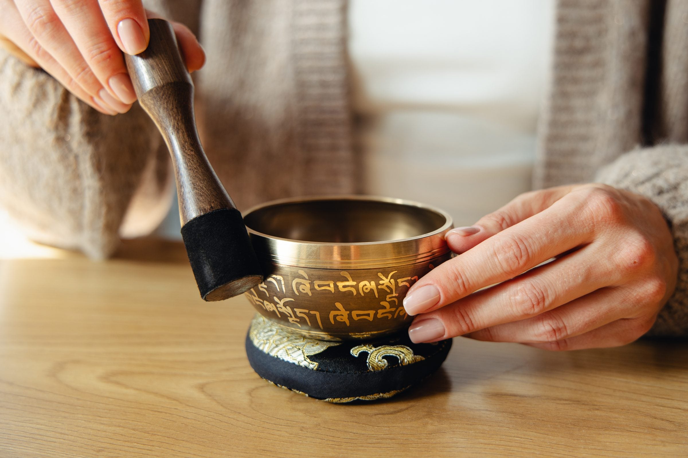 Golden Serenity singing bowl being played with the wooden striker